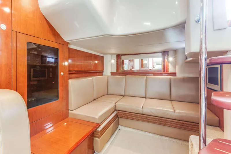 Slide: The Image of Interior of 2005 Sea Ray 390 Sundancer yacht with beige leather seating and wooden accents. - 2
