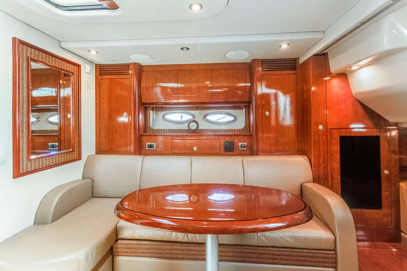 Slide: The Image of Luxurious interior of 2005 Sea Ray 390 Sundancer yacht with wood finishes and seating area. - 21