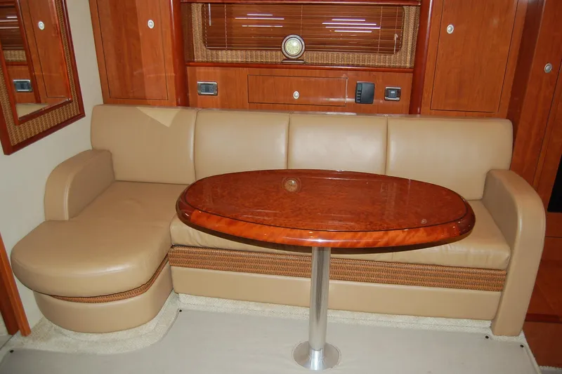 Slide: The Image of Luxurious interior of 2005 Sea Ray 390 Sundancer with leather seating and wooden table. - 22