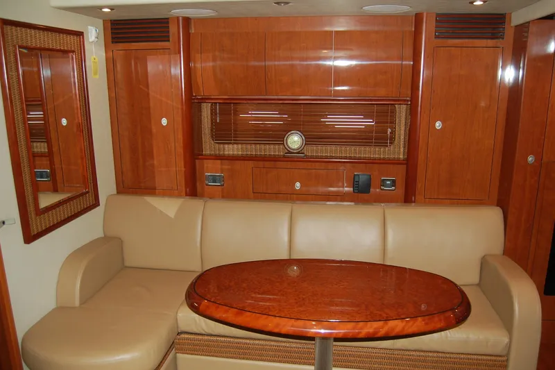 Slide: The Image of Luxurious interior of 2005 Sea Ray 390 Sundancer with leather seating and wooden cabinetry. - 23