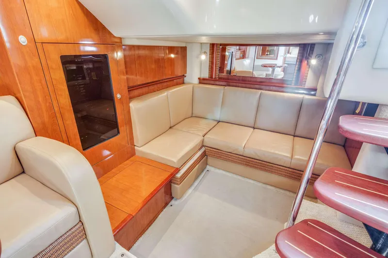 Slide: The Image of Luxurious interior of 2005 Sea Ray 390 Sundancer yacht with leather seating and wooden accents. - 26
