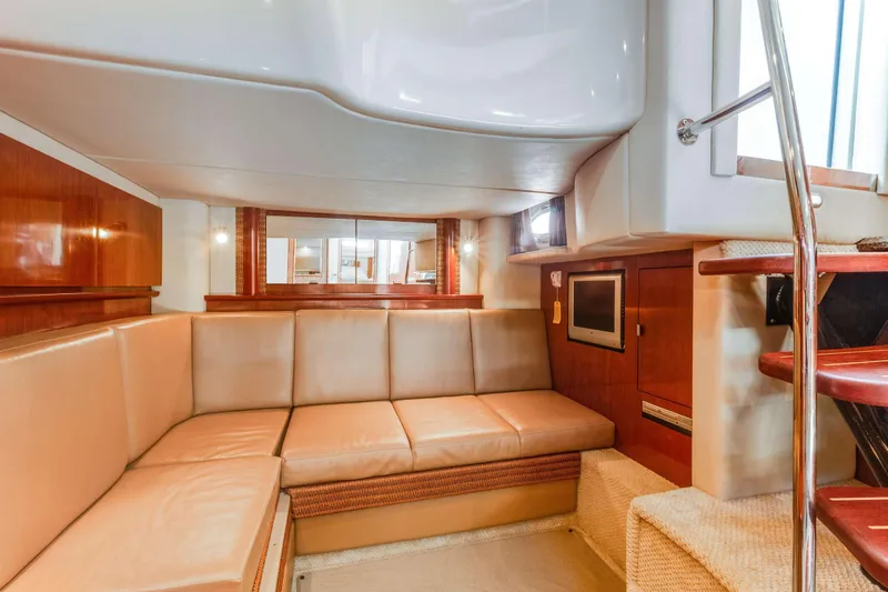Slide: The Image of Luxurious interior of 2005 Sea Ray 390 Sundancer yacht with beige seating and wood accents. - 27
