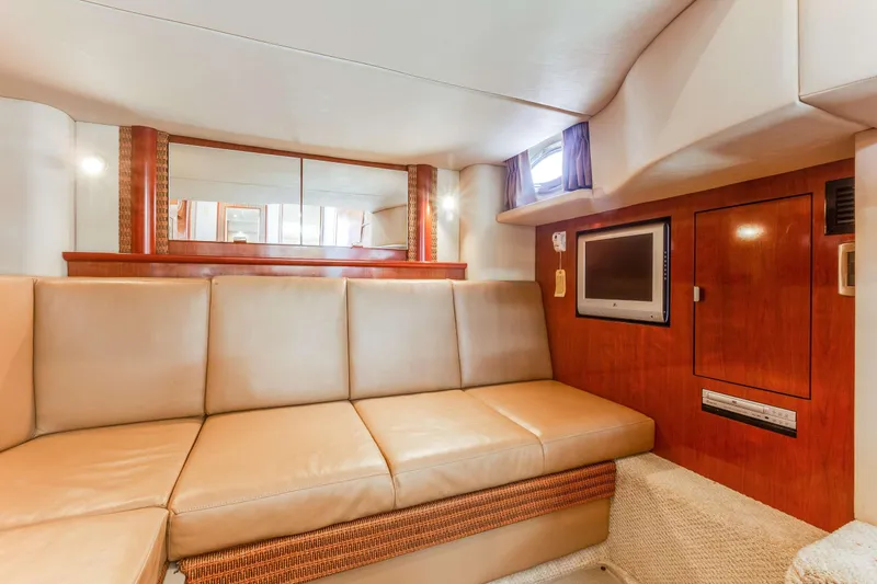 Slide: The Image of Interior of 2005 Sea Ray 390 Sundancer with beige seating and wood accents. - 28