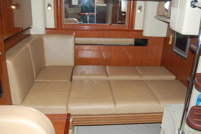 Slide: The Image of Interior of 2005 Sea Ray 390 Sundancer with beige leather seating and wooden accents. - 29