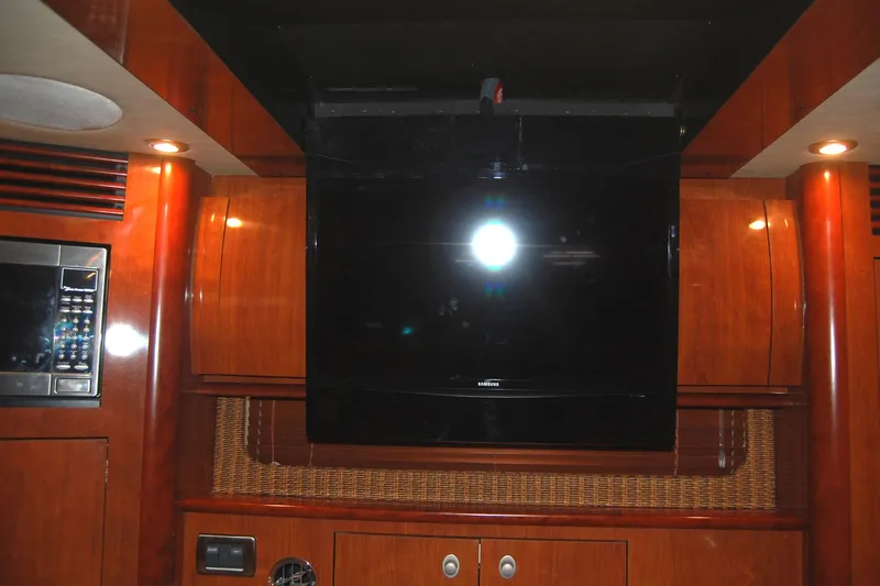 Slide: The Image of Interior of 2005 Sea Ray 390 Sundancer with TV and wooden cabinetry. - 33