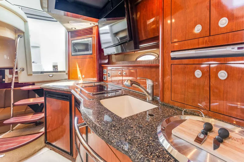Slide: The Image of Luxurious 2005 Sea Ray 390 Sundancer yacht interior with modern kitchen amenities. - 34