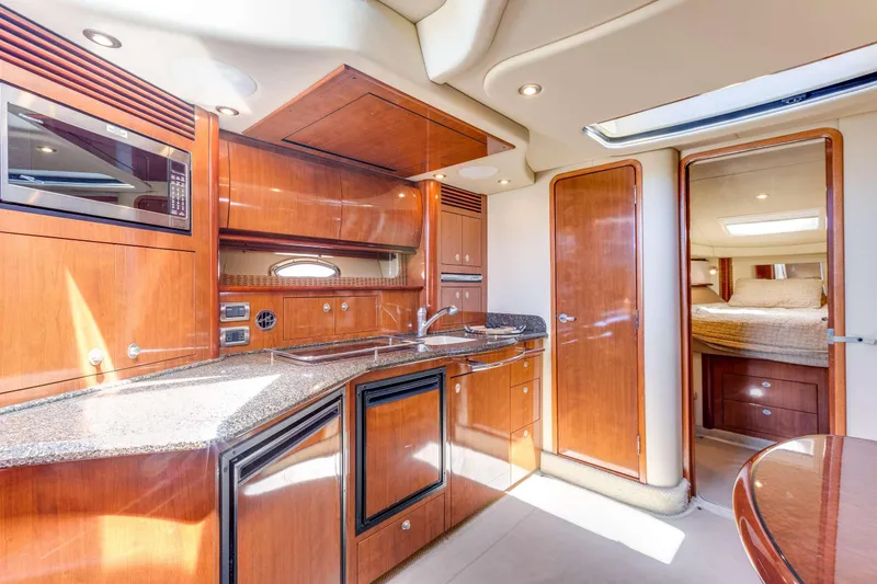 Slide: The Image of Luxurious interior of 2005 Sea Ray 390 Sundancer yacht with modern kitchen amenities. - 36