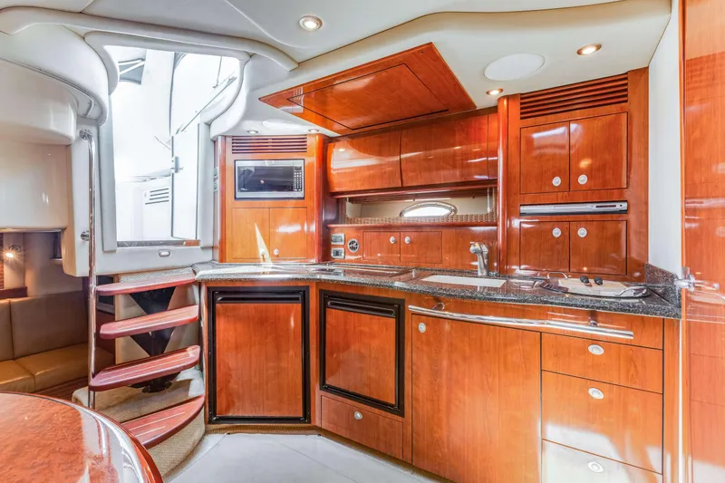 Slide: The Image of Luxurious 2005 Sea Ray 390 Sundancer yacht interior with modern kitchen and wooden cabinetry. - 37