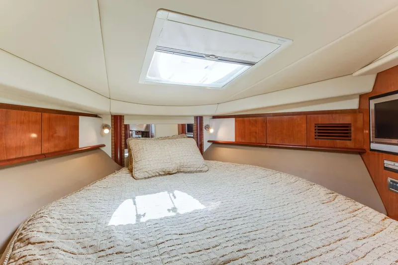 Slide: The Image of Luxurious cabin interior of 2005 Sea Ray 390 Sundancer yacht with cozy bedding. - 4