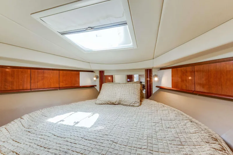 Slide: The Image of Luxurious cabin interior of 2005 Sea Ray 390 Sundancer with skylight and cozy bedding. - 40