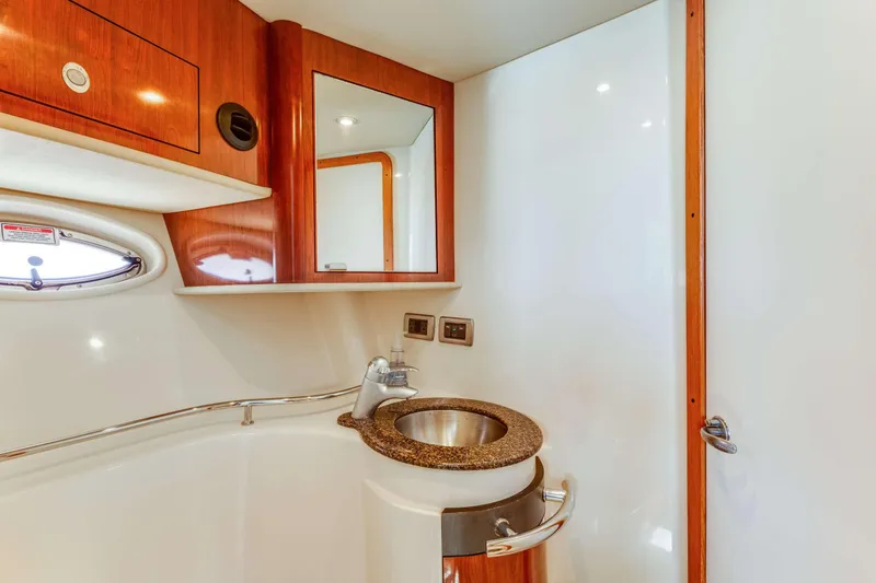 Slide: The Image of Luxurious bathroom in 2005 Sea Ray 390 Sundancer yacht with modern fixtures and wood accents. - 45