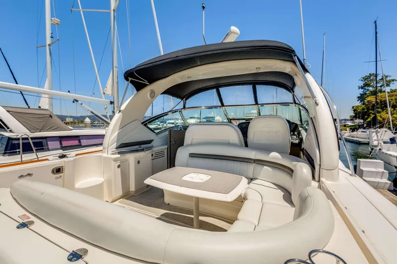 Slide: The Image of 2005 Sea Ray 390 Sundancer yacht with spacious seating and sleek design at marina. - 49