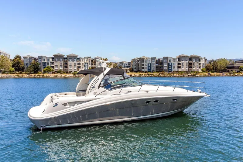 Slide: The Image of 2005 Sea Ray 390 Sundancer yacht on calm water with buildings in the background. - 6
