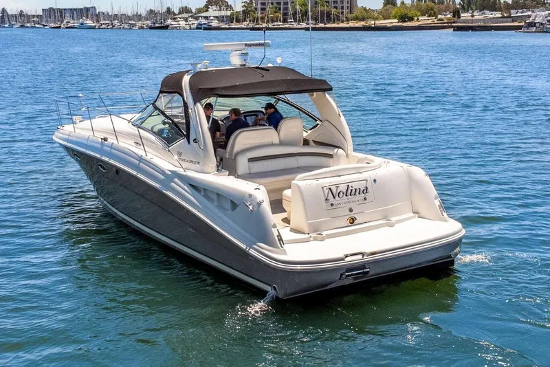 Slide: The Image of 2005 Sea Ray 390 Sundancer yacht cruising on a sunny day in a marina. - 8