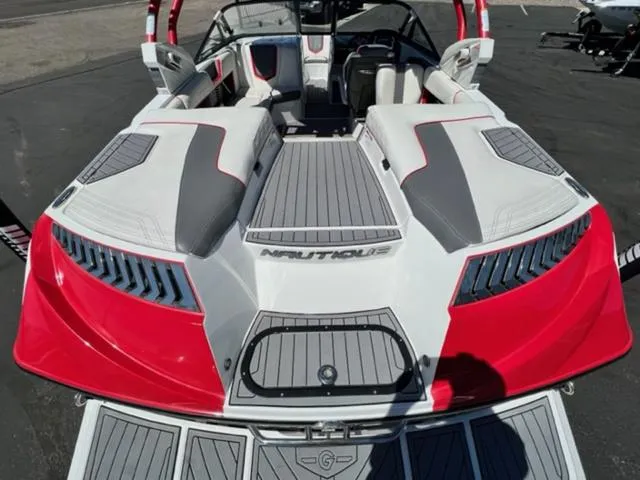 Slide: The Image of 2016 Nautique G21 boat with red and gray accents, rear view. - 10