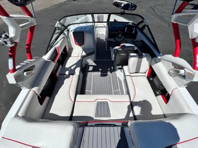 Slide: The Image of 2016 Nautique G21 boat interior with white and red seating, gray flooring. - 11