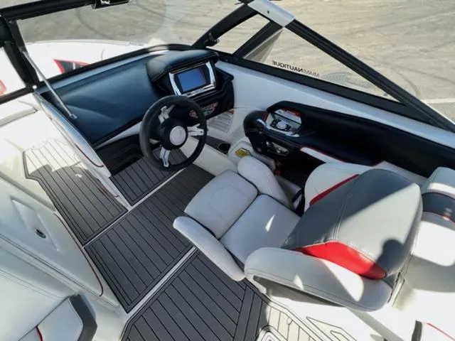 Slide: The Image of 2016 Nautique G21 boat interior with modern dashboard and seating. - 12
