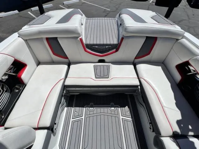 Slide: The Image of 2016 Nautique G21 boat interior with white and gray seating, red accents. - 15