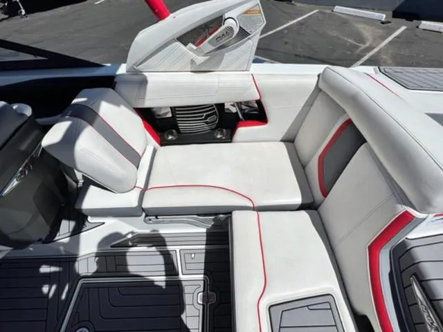 Slide: The Image of 2016 Nautique G21 boat interior with white and red seating. - 16