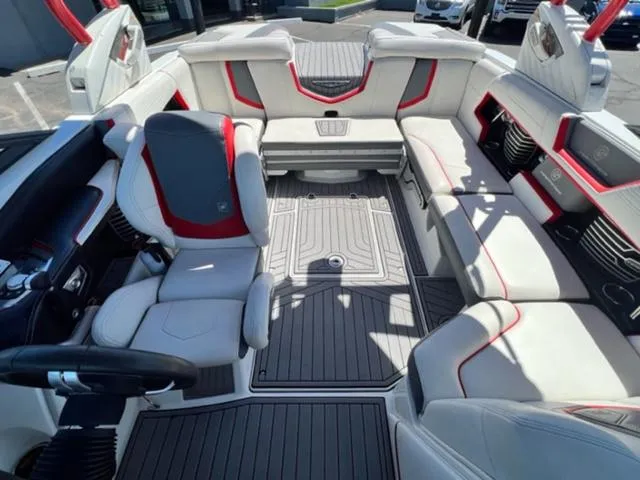 Slide: The Image of 2016 Nautique G21 boat interior with gray and red seating. - 18