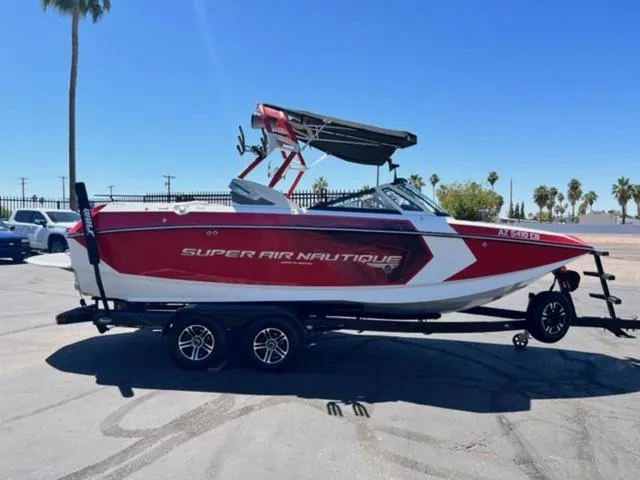 Slide: The Image of 2016 Nautique G21 Super Air boat in red and white on a trailer. - 5
