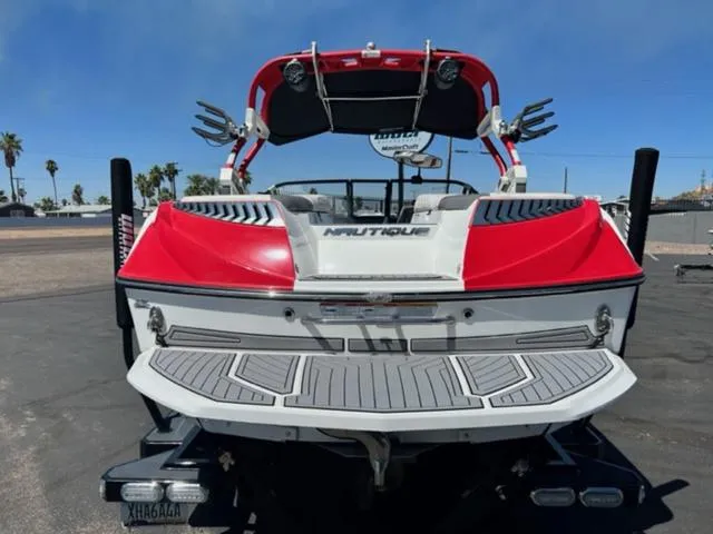 Slide: The Image of 2016 Nautique G21 boat with red and white exterior, rear view. - 7