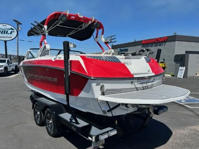 Slide: The Image of 2016 Nautique G21 red and white boat on a trailer in a dealership lot. - 8
