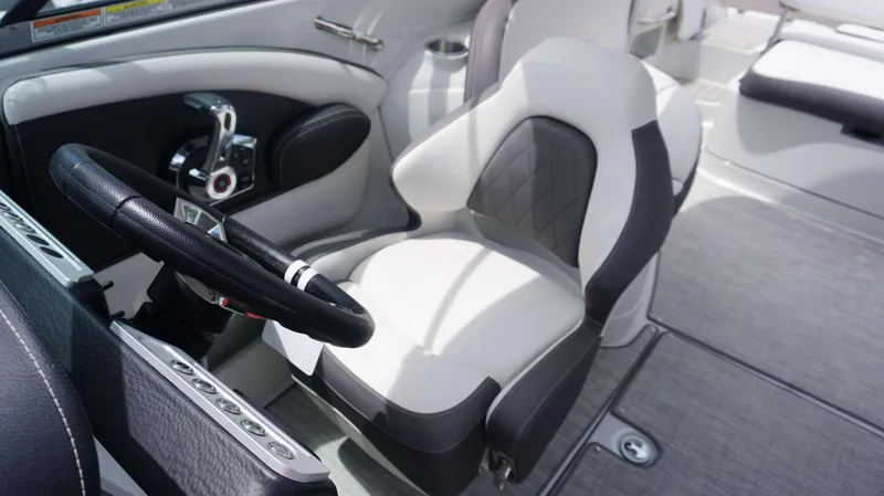Slide: The Image of 2024 Crownline 290 XSS boat interior with steering wheel and seating. - 10
