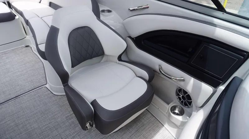 Slide: The Image of 2024 Crownline 290 XSS boat interior with luxurious seating and modern dashboard. - 11