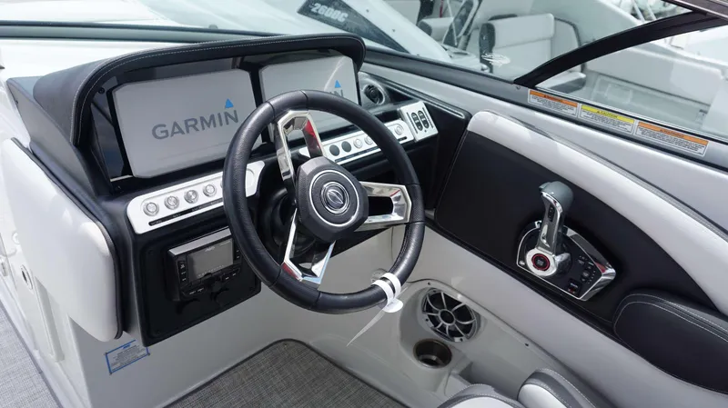 Slide: The Image of 2024 Crownline 290 XSS boat dashboard with Garmin navigation system and modern controls. - 15