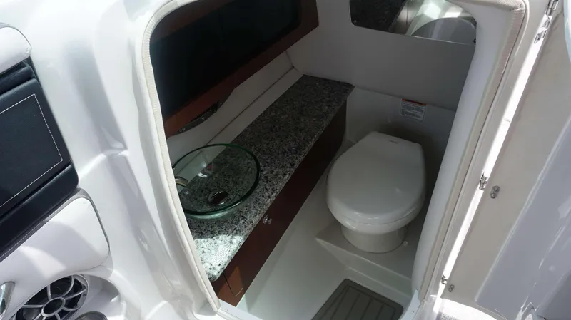 Slide: The Image of 2024 Crownline 290 XSS boat bathroom with granite countertop and modern fixtures. - 17