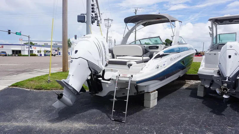 Slide: The Image of 2024 Crownline 290 XSS boat displayed on blocks in a parking lot. - 3