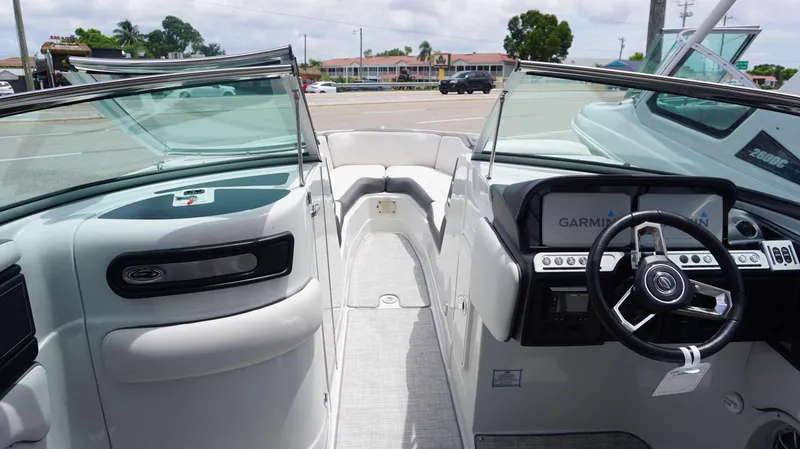 Slide: The Image of 2024 Crownline 290 XSS boat interior with steering wheel and dashboard view. - 6