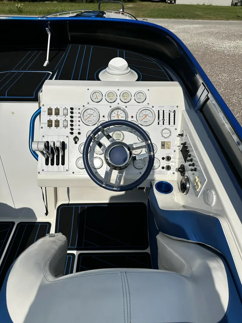 Slide: The Image of 2002 Fountain 42 Lightning boat cockpit with steering wheel and control panel. - 10