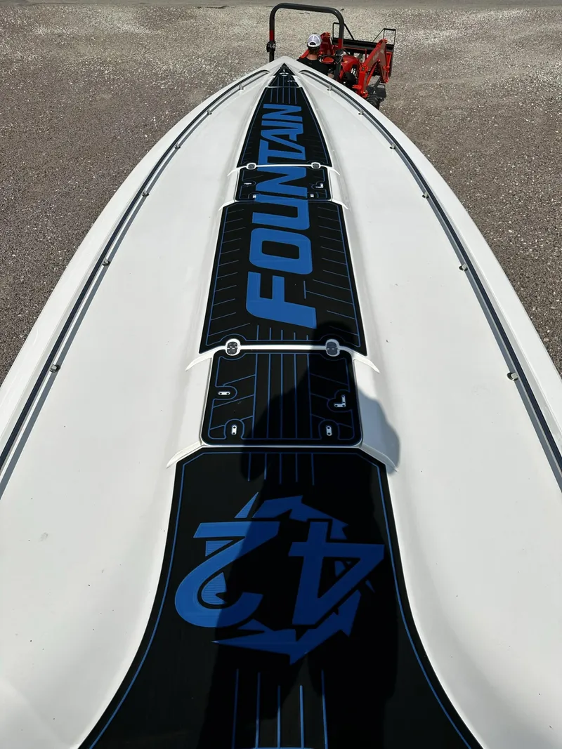 Slide: The Image of 2002 Fountain 42 Lightning speedboat, top view showcasing sleek design and branding. - 11