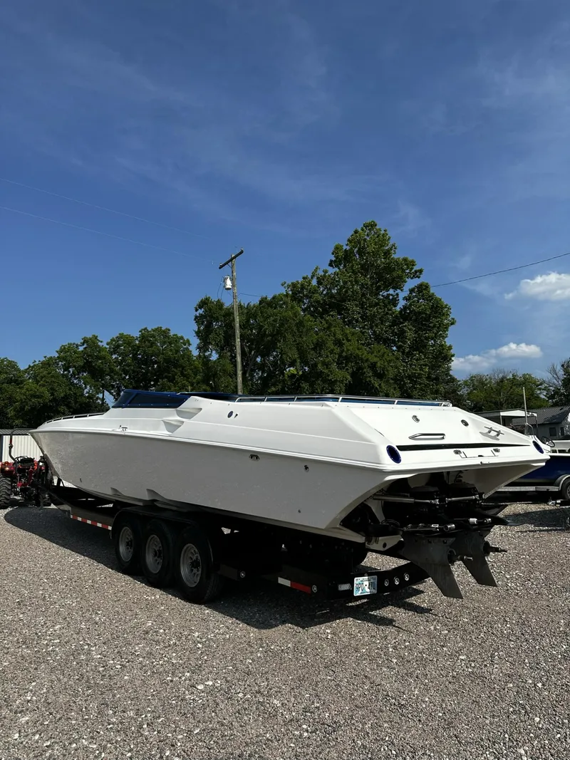 Slide: The Image of 2002 Fountain 42 Lightning speedboat on a trailer in a gravel lot. - 2