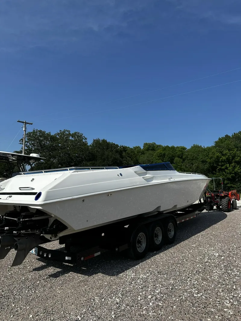 Slide: The Image of 2002 Fountain 42 Lightning speedboat on a trailer in a gravel lot. - 4