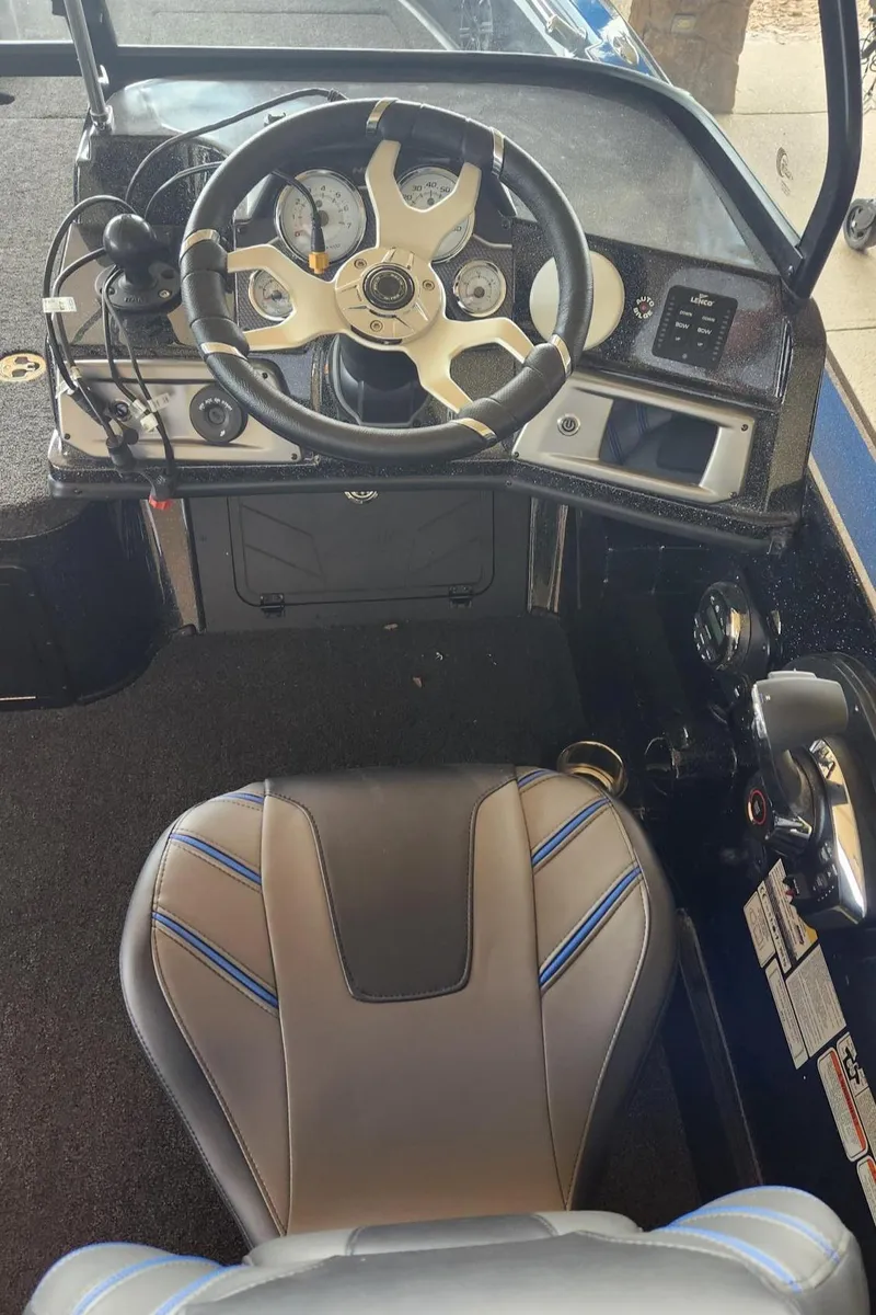 Slide: The Image of Cockpit view of 2023 Nitro ZV20 Pro boat with steering wheel and captain's chair. - 2