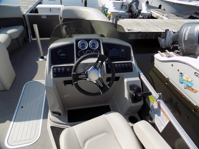 Slide: The Image of 2021 Sylvan Mirage 8522 LZ boat dashboard with steering wheel and controls. - 4