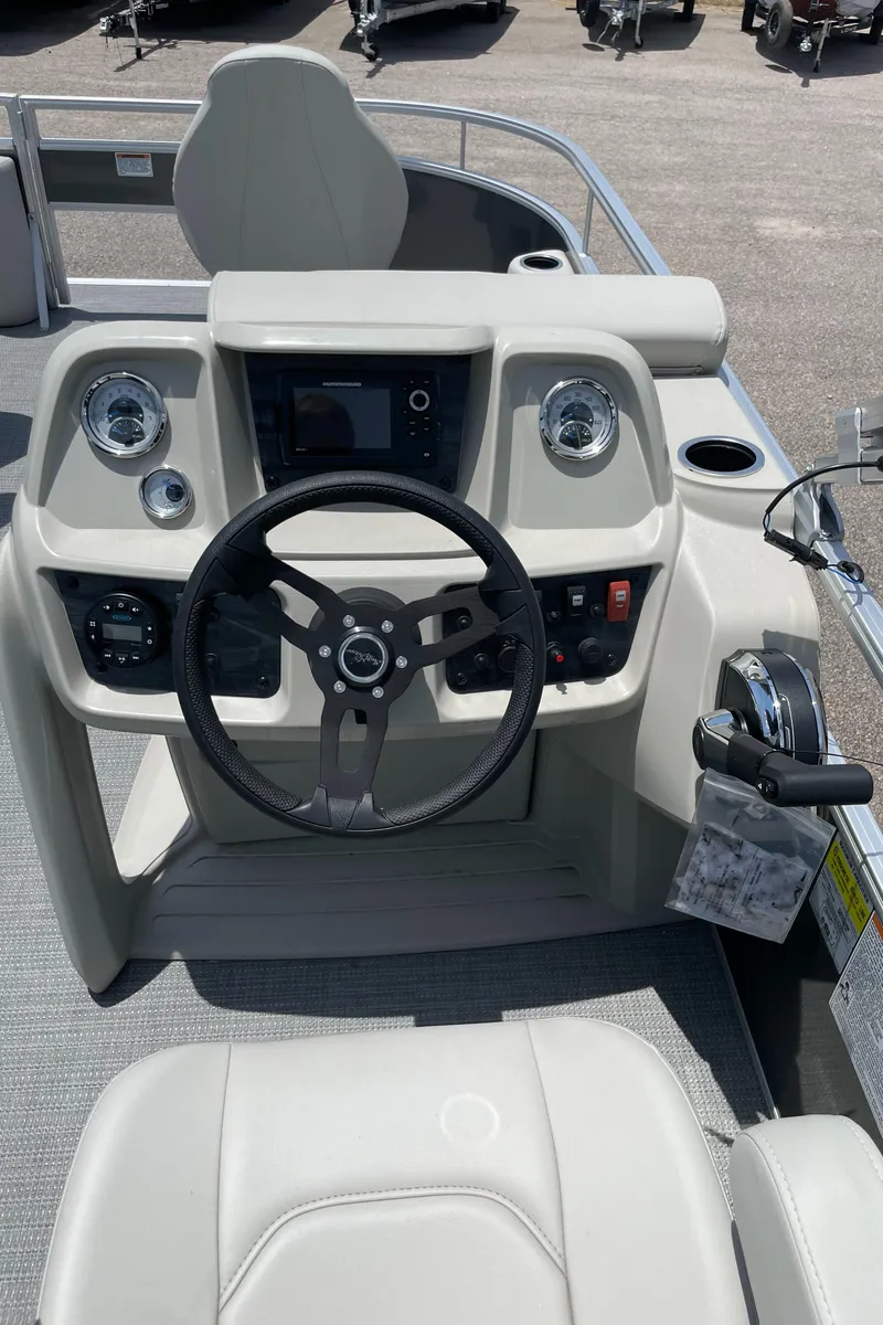 Slide: The Image of 2023 SunChaser Vista 16 Fish boat console with steering wheel and controls. - 7
