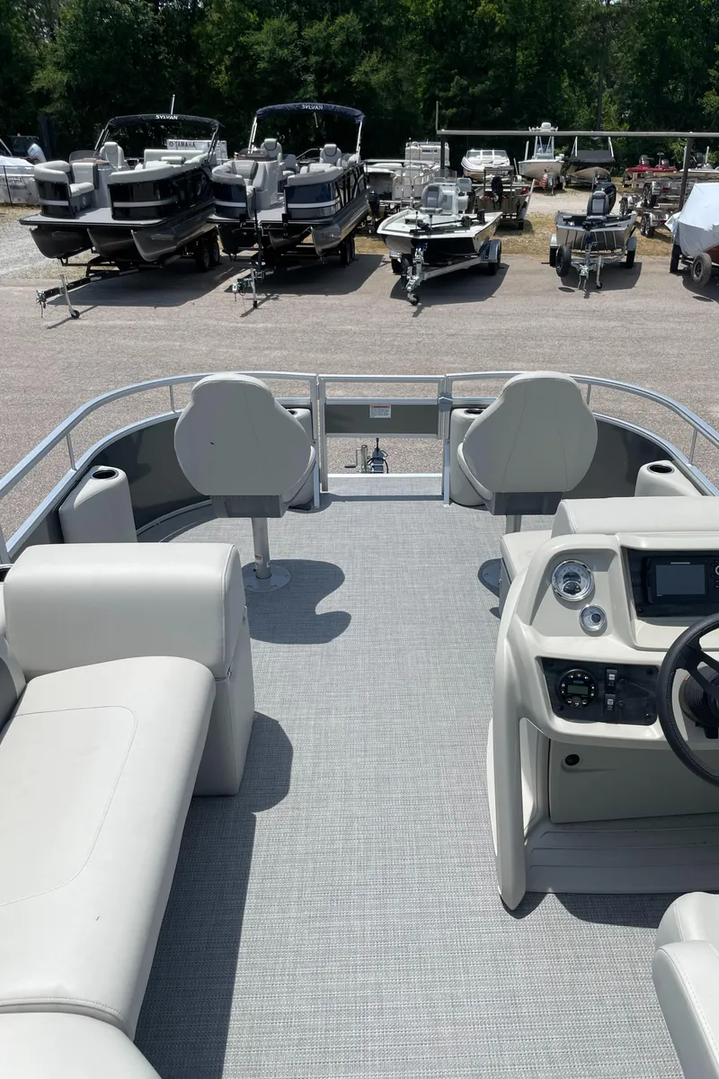 Slide: The Image of 2023 SunChaser Vista 16 Fish pontoon boat interior with seating and control console. - 9