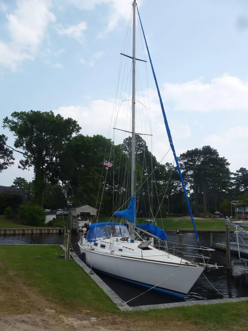 Slide: The Image of 1984 Morgan 454 sailboat docked with blue sails. - 10