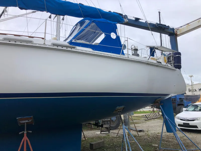 Slide: The Image of 1984 Morgan 454 sailboat in shipyard, blue and white paint. - 12