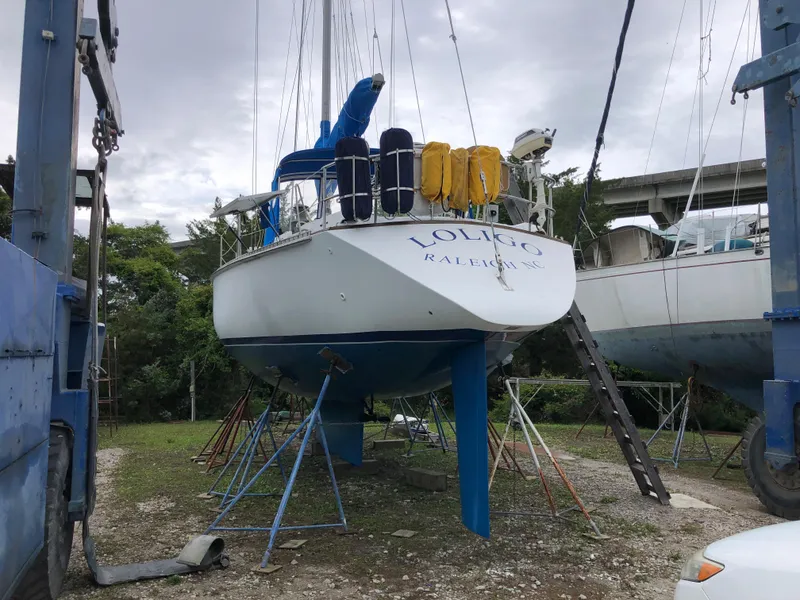 Slide: The Image of 1984 Morgan 454 sailboat propped up outdoors. - 13