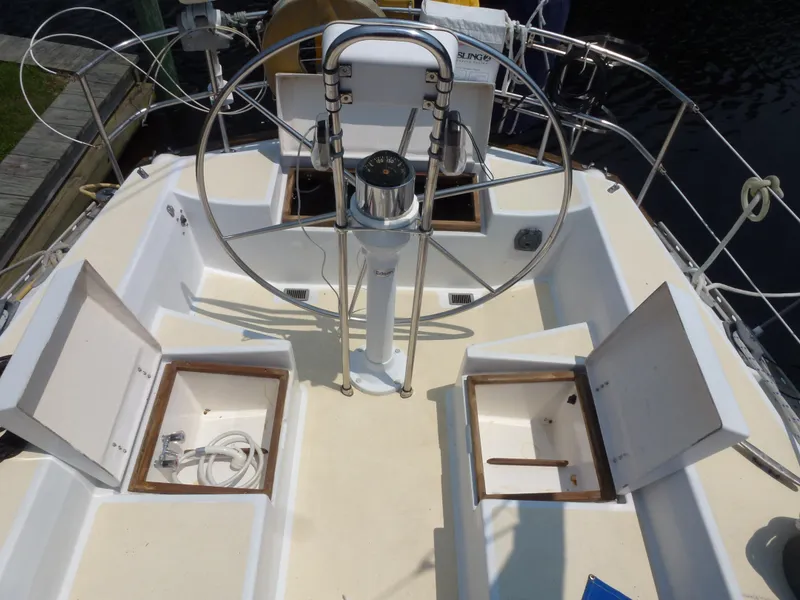 Slide: The Image of Cockpit of a 1984 Morgan 454 sailboat with steering wheel and storage. - 16