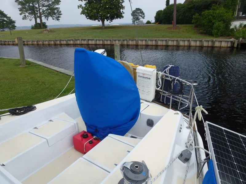 Slide: The Image of 1984 Morgan 454 sailboat docked by a tranquil canal. - 20