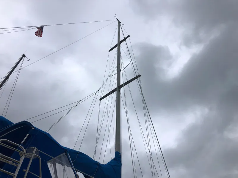 Slide: The Image of Mast of a 1984 Morgan 454 sailboat against cloudy sky. - 21