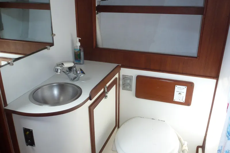 Slide: The Image of 1984 Morgan 454 boat bathroom interior with sink and toilet. - 33