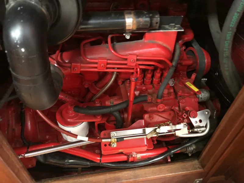 Slide: The Image of Close-up of a red engine in a 1984 Morgan 454 boat. - 38