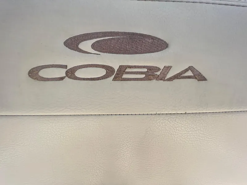 Slide: The Image of Cobia 220 logo on beige leather, 2020 model boat branding. - 16